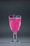 luxury alcohol pink cocktail drink with basil in glass on grey background