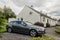 Luxury Audi A4 Avant B8 station wagon car parked in front of the white family house in Scotland. The living of the rich family