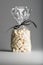 Luxury bag of dried coconut cubes isolated with elegant ribbon