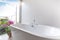 Luxury bathroom features bathtub with flower