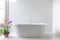Luxury bathroom features bathtub with flower