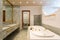 Luxury bathroom with large hydromassage, green marble and gold sinks