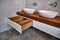 Luxury bathroom vanity. Stylish interior of modern bathroom with teak tabletop and marble walls