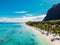 Luxury beach with mountain in Mauritius. Sandy beach with palms and ocean. Aerial view