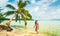 Luxury beach vacation Tahiti Bora Bora bikini woman swimming in paradise getaway destination. Beautiful Asian swimsuit