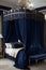 luxury bedroom with blue velvet upholstered furniture and gold curtains
