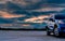 Luxury blue SUV car parked on land beside tropical forest with beautiful sunrise sky. New car with sport and modern design. Car