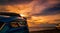 Luxury blue SUV car parked on the road beside tropical beach with beautiful sunset sky. New car with sport and modern design. Car