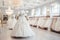 Luxury bridal dresses on hangers, showcasing elegant white wedding gowns in a boutique salon