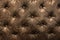 Luxury brown or black leather with button texture background closeup