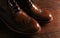 Luxury brown shoes on wood background