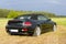 Luxury cabriolet in rural scene, backview