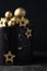 Luxury cake with dark blue cream cheese frosting decorated with golden chocolate stars and spheres. Birthday space themed cake on