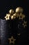 Luxury cake with dark blue cream cheese frosting decorated with golden chocolate stars and spheres. Birthday space themed cake on