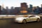 Luxury car in motion in front of Manhattan skyline