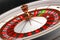 Luxury Casino roulette wheel on black background. Casino theme. Close-up white casino roulette with a ball on zero