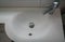 Luxury ceramic washbasin with stainless faucet in hotel bathroom