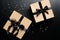 Luxury Christmas gift boxes with ribbon bow on black background with confetti. Xmas presents, New Years surprises. Flat lay, top