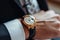 Luxury close up man adjusts gold watch, showcasing mens fashion