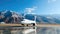 Luxury corporate business jet on runway with background of high scenic mountains