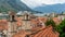 A Luxury Cruise Ship in Kotor Montenegro. Liner Seven Seas Voyager in the port. Coast Town in the balkans and orange roof tiles