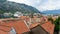 A Luxury Cruise Ship in Kotor Montenegro. Liner Seven Seas Voyager in the port. Coast Town in the balkans and orange roof tiles