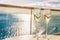 Luxury cruise ship travel champagne glasses on balcony deck with ocean sunset view on Caribbean vacation. Drinks in sun flare on