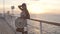 Luxury cruise ship travel elegant tourist woman posing watching sunset on balcony deck of Europe mediterranean cruising