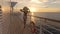 Luxury cruise ship travel elegant tourist woman watching sunset on balcony deck