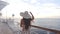 Luxury cruise ship travel elegant tourist woman watching sunset on balcony deck of Europe mediterranean cruising