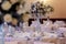 luxury decorated tables at rich wedding reception. stylish arrangements of flowers and jewels on table in glass vase, dish and