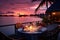 Luxury dinner on table waiting for guest at sunset in luxury vacation resort at beach. Summer tropical vacation concept.