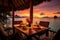 Luxury dinner on table waiting for guest at sunset in luxury vacation resort at beach. Summer tropical vacation concept.