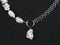 Luxury elegant baroque pearl necklace with pendant on black textured background