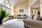 Luxury family room in soft creamy tones with hight ceiling and a