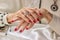 Luxury female hands with red manicure.