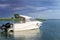 Luxury fishing motor boat moored at coast in bay on river or lake. Dark stormy sky with thunder clouds on background. Travel and r