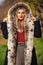 Luxury fur. Beauty and fashion. Woman wear coat with huge furry hood. Fake fur fabric. Elegant girl walk in autumn park