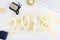 Luxury glowing numbers 2018 made from gold shiny glitter on white table with keyboard and christmas decoration.