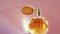 Luxury golden perfume bottle and shining light flares on pink background, glamorous fragrance scent as perfumery product