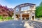 Luxury gray house with white trim and two motor boats in garage.