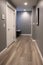 Luxury hallway with gray walls and hardwood floor. Baseboard.