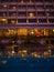 Luxury hotel swimming poolside view with restaurant light reflection in pool water