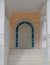 A luxury house entrance marble stairs to white arched door