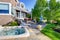 Luxury house exterior with impressive backyard design, patio area and hot tub.