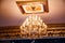 Luxury interior chandelier has light candles.