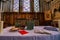 Luxury interior of a church with medieval windows and Holy books, a cross, and decorations