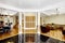 Luxury interior. Foyer with black shiny tile floor, columns and