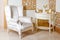 Luxury Interior. Luxurious white armchair, antique carved furniture, classic room interior detail.