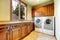 Luxury laundry room with wood cabinets.